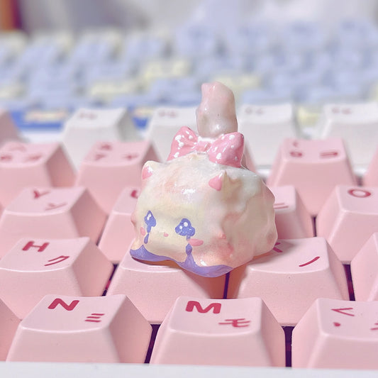 Handmade Crying Cat Mechanical Keyboard Keycap on a keyboard with other pink key caps in Japanese