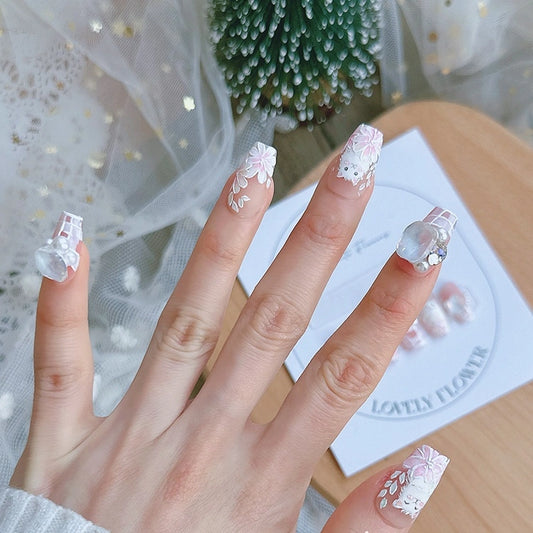 Handmade pink press-on nails with white cat and flower design, cat-themed nail art gift