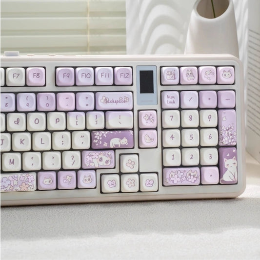 Cute white cat-themed purple keycap set with floral accents, perfect for gamers.