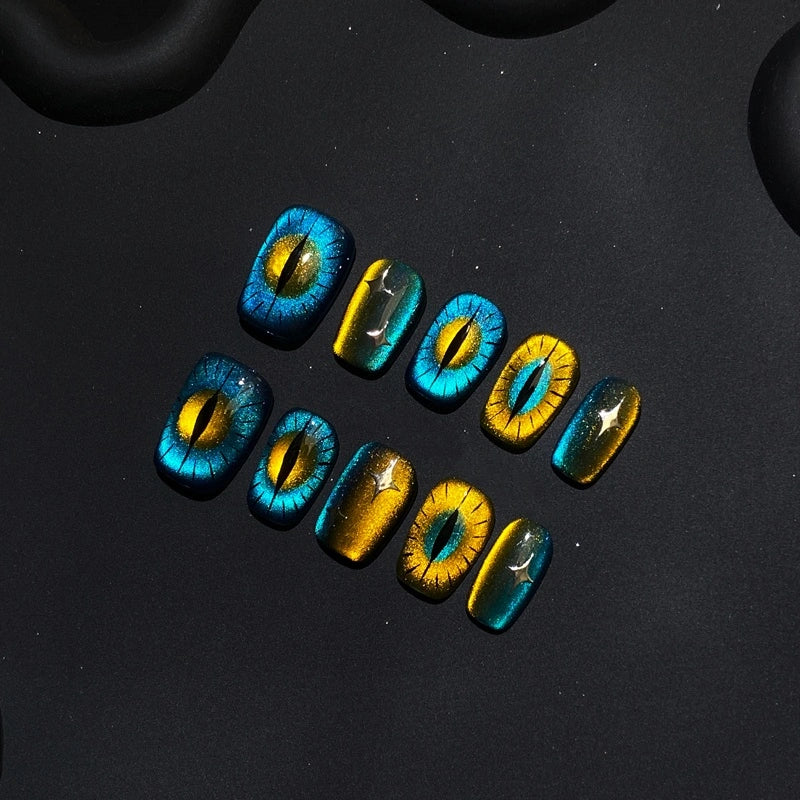 Feline Glow Show Handmade Press-On Nails featuring cat-eye design with blue and gold accents.