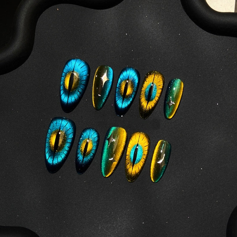 Handmade Feline Glow Show Press-On Nails showcasing glittery blue and gold hues.
