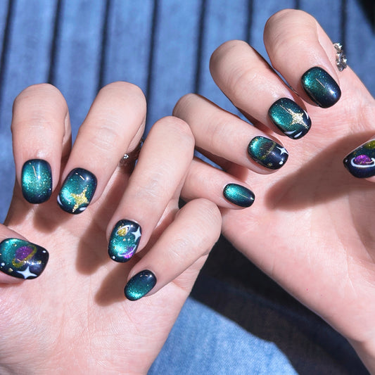 Galaxy glitter cat-eye press-on nails with Cosmic Kitty design, featuring sparkling hearts, stars, and swirling space patterns.