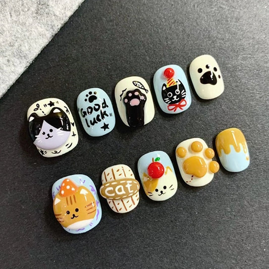 Handmade cute cat press-on nails featuring ginger and tuxedo cats, perfect for cat lovers