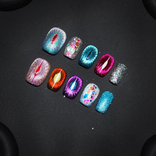 Close-up of Goddess Purr-glow cat-eye nails with sparkling details and bold colors.