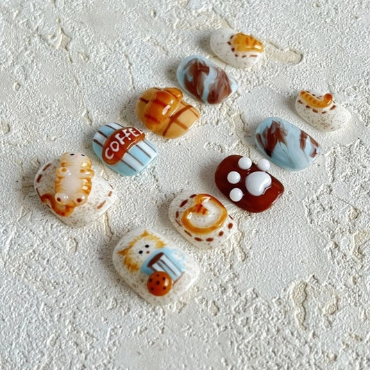 Purr-fect Paws & Latte Claws press-on nails with adorable paw print and cat-themed nail art