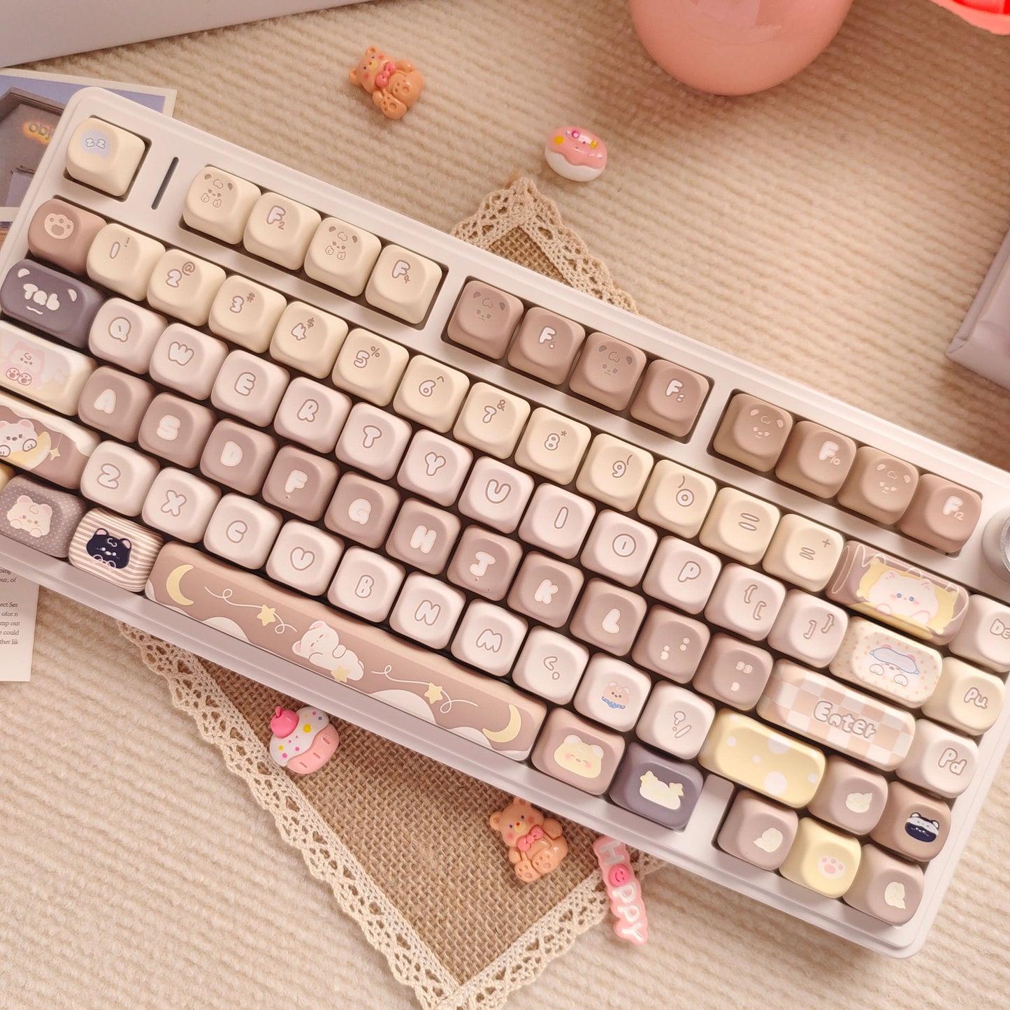 Mechanical keyboard keycap set in coffee-inspired colors with playful cat and moon designs.