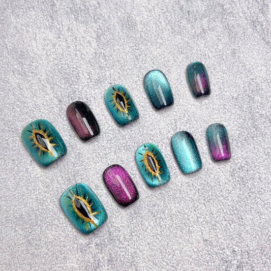 Mystical cat-eye nail art for cat lovers – Mystic Kitty Gaze press-on nails with an enchanting glow.
