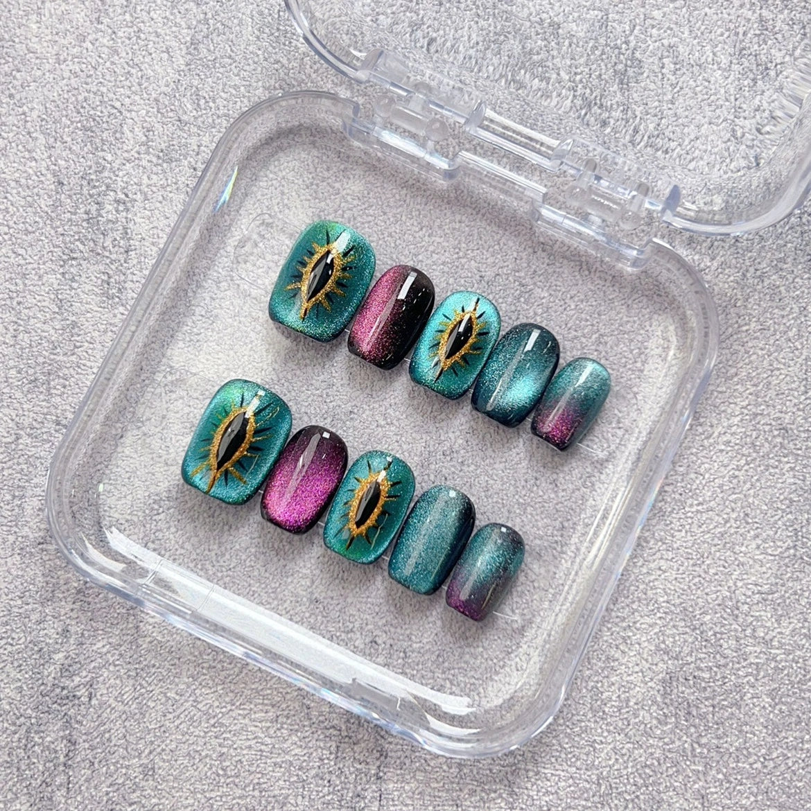 Mystic Kitty Gaze press-on nails showcasing a sparkling cat-eye pattern perfect for a magical, stylish look.