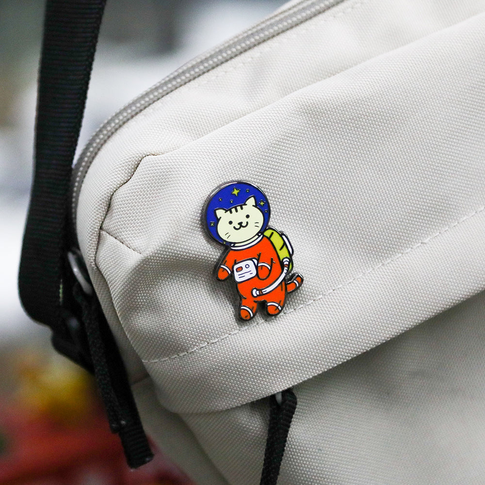 Cat Astronaut Pin on the backpack. Pawsome decor for backpack and camera strap.