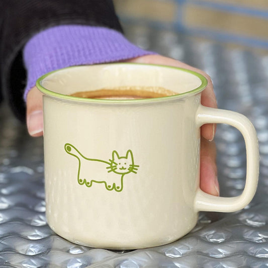 Woman Holding the Fais un Beau Rêve Coffee Mug, Matcha Color with Cut Cat illustration. Pawsome Gift for Cat Lovers and Cat Owners.