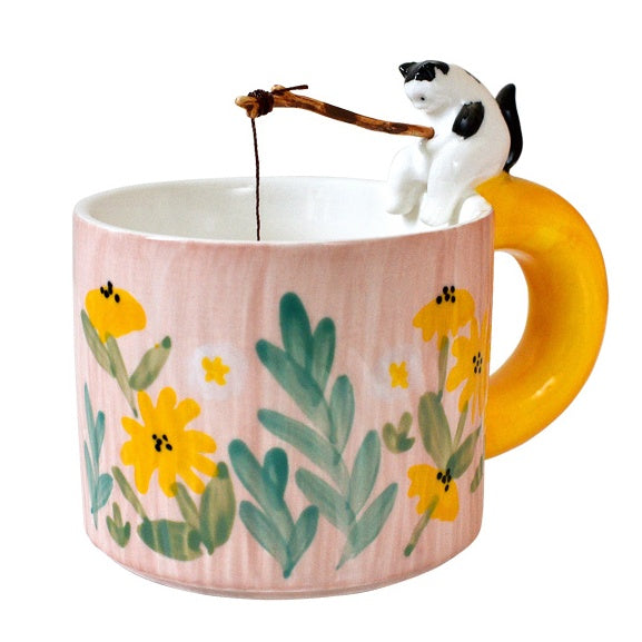 Cat Go Fishing Handmade Coffee Mug, Pink mug with flower print, Tuxedo Cat sitting on the mug with fishing rod in it's hand