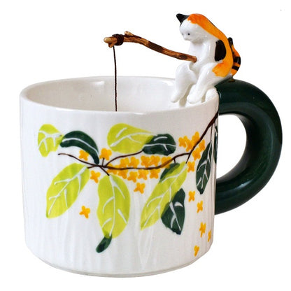 Cat Go Fishing Handmade Coffee Mug, white mug with flower print, Calico Cat sitting on the mug with fishing rod in it's hand