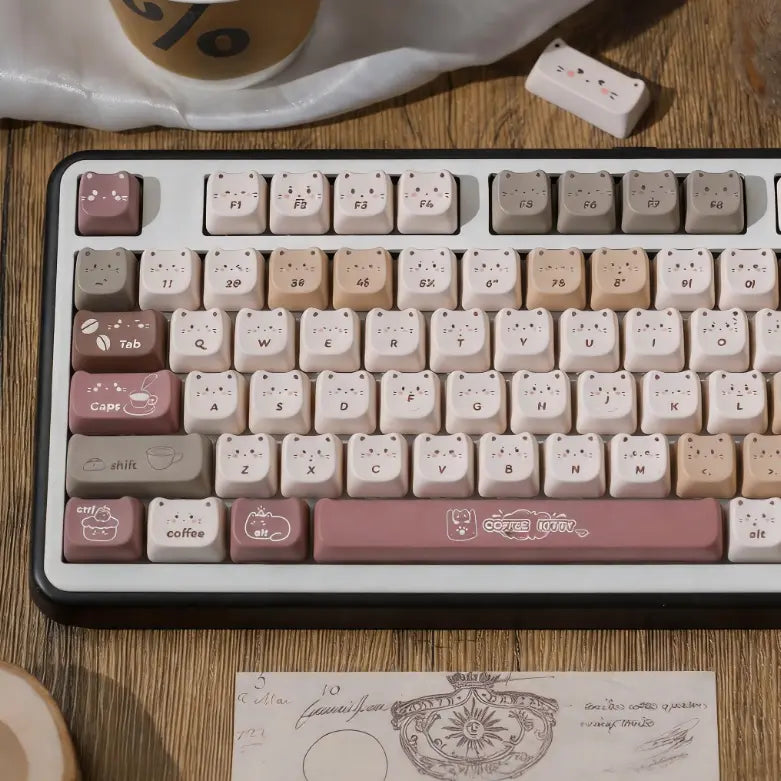 Cozy cafe themed MAO profile keycaps with coffee bean and cat face motifs.