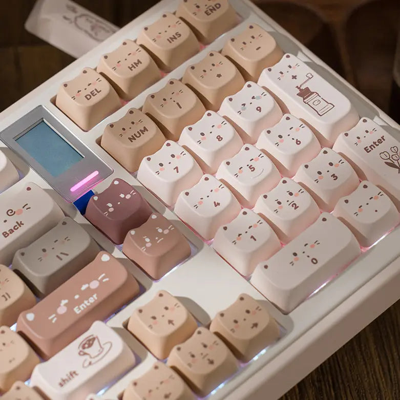 Hand-drawn coffee kitty cat ear keycaps in mocha and beige on a mechanical keyboard.