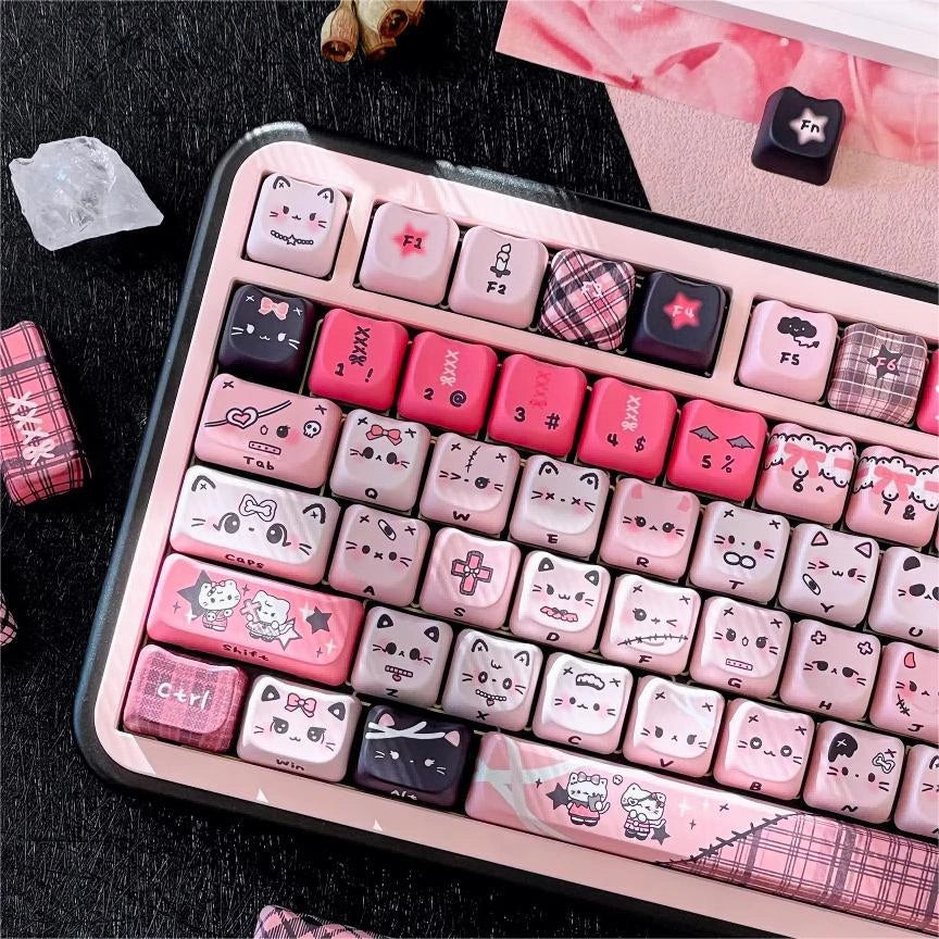 Gothic Meow Dream keycap set featuring pink and black colors with cute cat designs and lace details on a keyboard