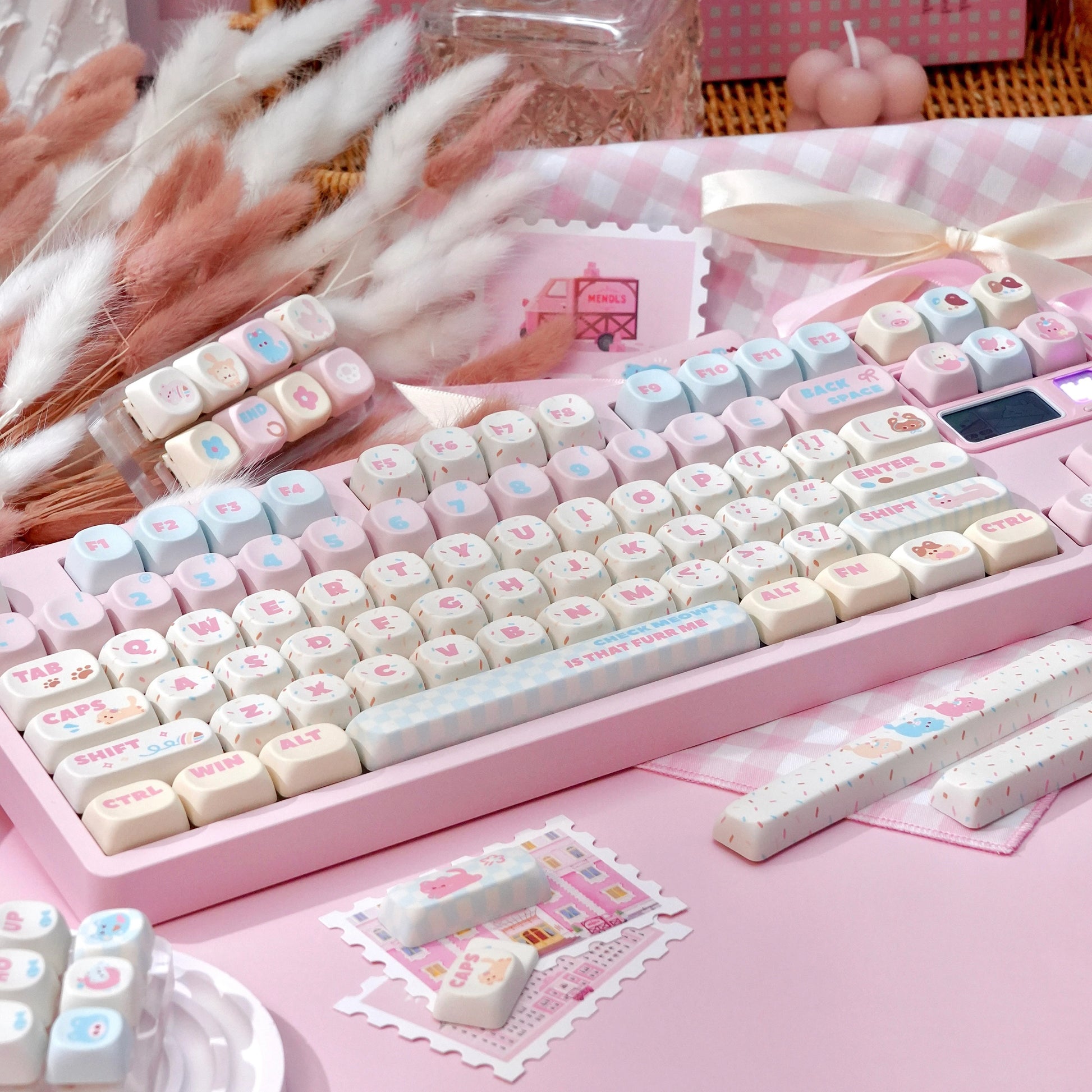 pink and cream keycaps with cute cat icons and cherry profile