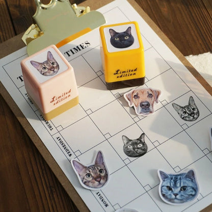 Yellow and pink custom pet stamps displayed on a sheet alongside matching cat and dog stickers, showcasing the bonus stickers included with the stamps.