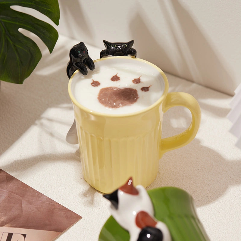 Cute cat-themed ceramic coffee mug featuring black cats, perfect for tea or coffee lovers.