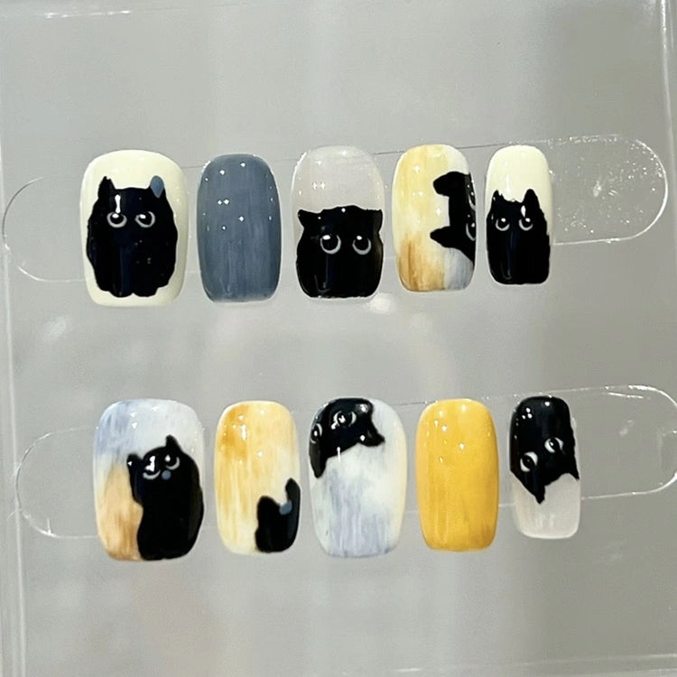 Cute black cat nail art on Whisker Shadows press-on nails for a unique, playful look.