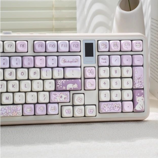 Cute white cat-themed purple keycap set with floral accents, perfect for gamers.