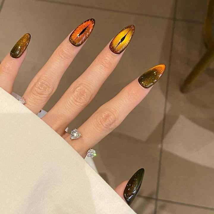 Flaming Feline Fierce cat-eye nails glowing with bold orange flames for a fierce, bold look
