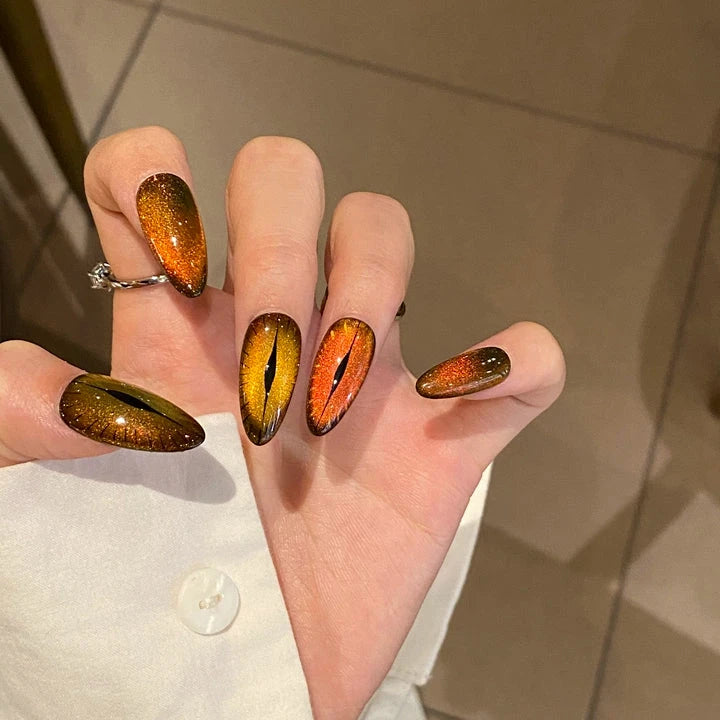 Close-up of Flaming Feline Fierce cat-eye press-on nails showing intricate details of fiery design
