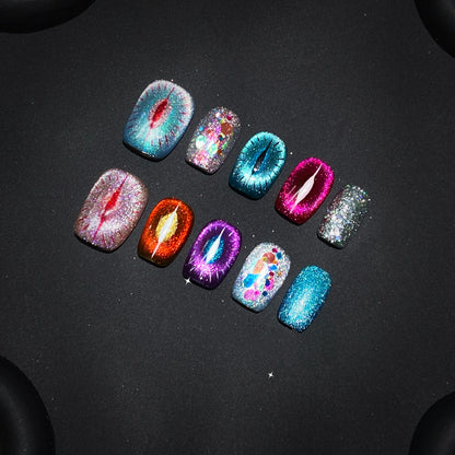 Close-up of Goddess Purr-glow cat-eye nails with sparkling details and bold colors.
