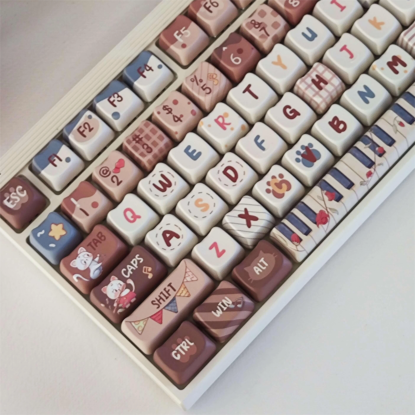 Top view of Kitty Concert Keycap Set featuring brown cat-themed keycaps with musical elements.