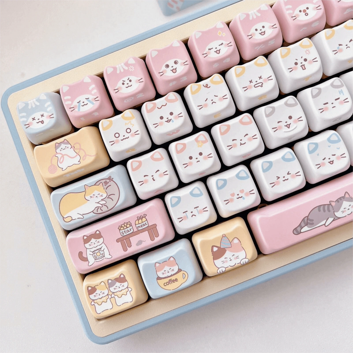 Kitty's Wonderland keycap set featuring cute cat faces in pastel colors