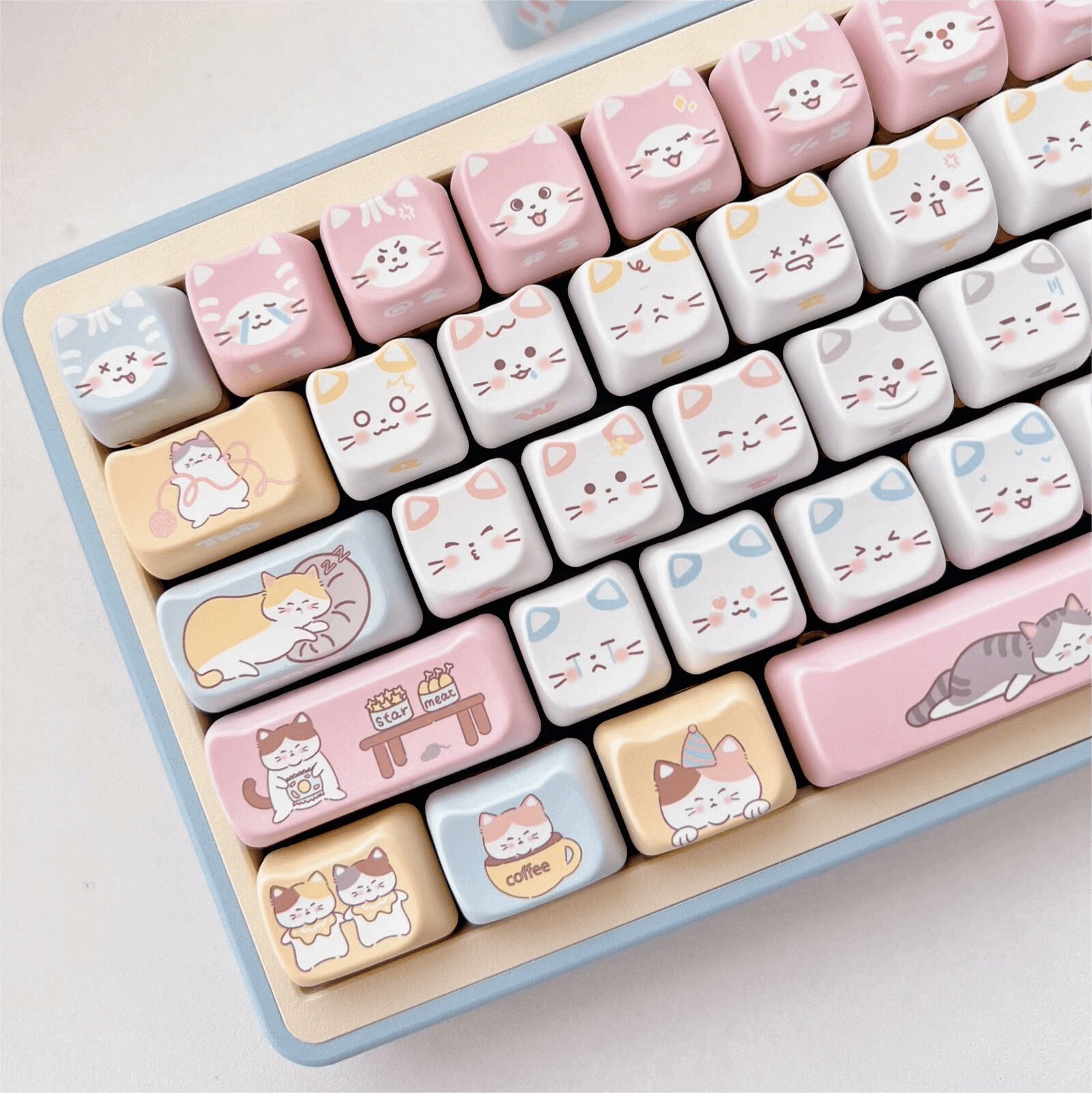 Kitty's Wonderland keycap set featuring cute cat faces in pastel colors