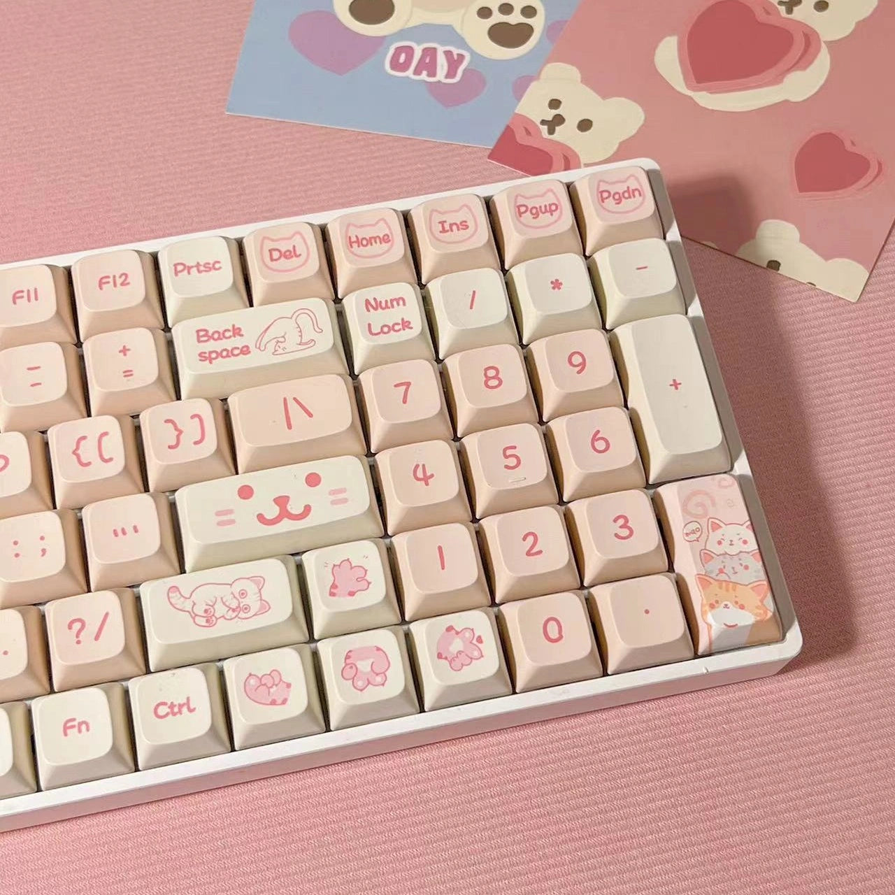 Pink mechanical keyboard keycaps with charming cat designs, ideal gift for gamers and cat enthusiasts.