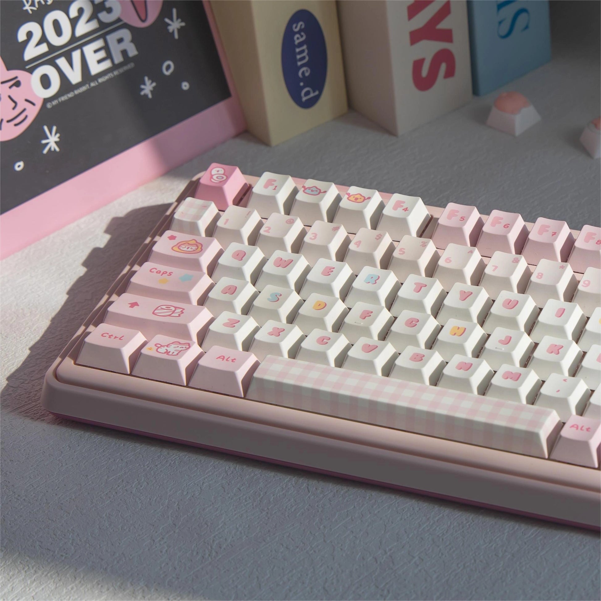 Full view of the Pooping Kitty Keycap Set featuring pink and white keycaps with cute cat and toilet paper designs.