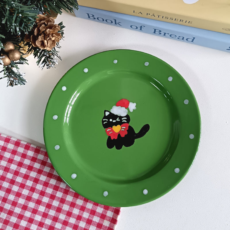 Green ceramic plate featuring a black cat in Santa hat for holiday decor
