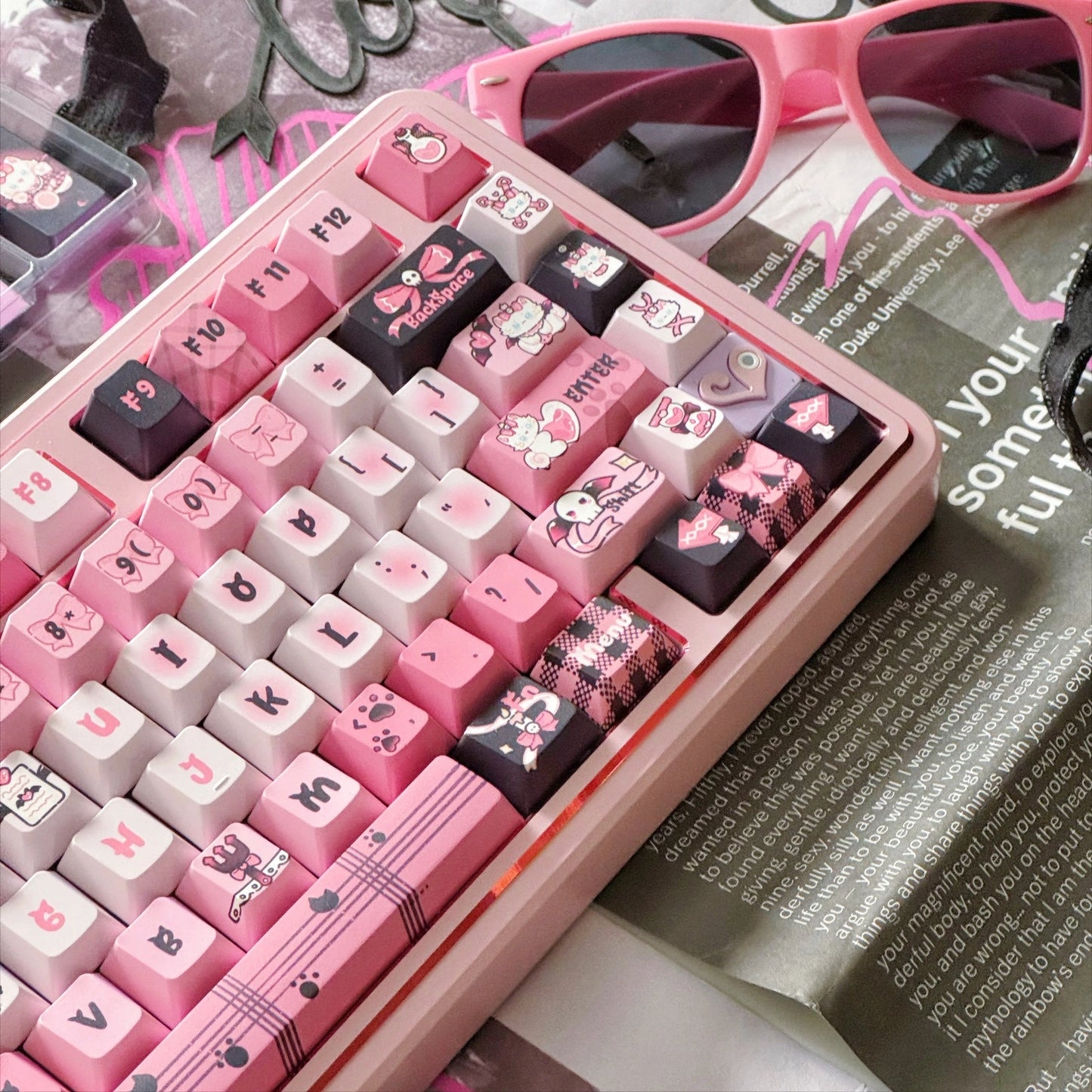 Mechanical keyboard keycaps with white cat illustrations in a stylish black and pink color palette.