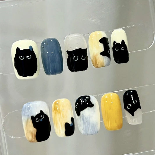 Whisker Shadows handmade press-on nails featuring cute black cat designs, perfect for cat lovers.