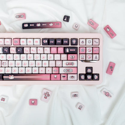 Pink and black cat-themed keycaps with adorable details on a mechanical keyboard.